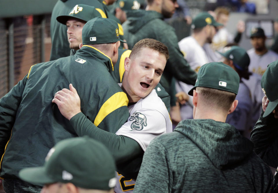 Oakland Athletics' Matt Chapman hugs teammates before a baseball game against the Seattle Mariners, Monday, Sept. 24, 2018, in Seattle. (AP Photo/John Froschauer)