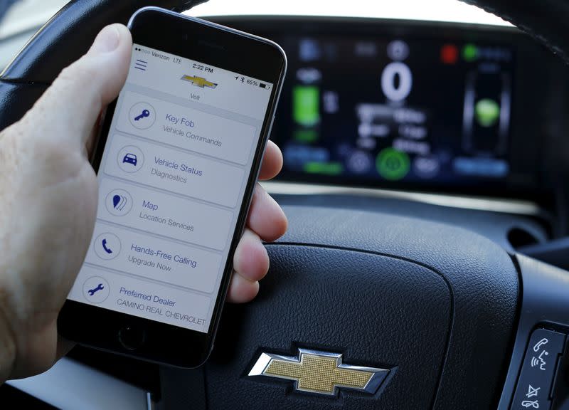 FILE PHOTO: A mobile phone displays the OnStar app inside a Chevrolet Volt vehicle in this photo illustration taken in Encinitas