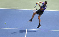 Grigor Dimitrov, of Bulgaria, returs against Alex de Minaur, of Australia, during the fourth round of the US Open tennis championships Sunday, Sept. 1, 2019, in New York. (AP Photo/Jason DeCrow)