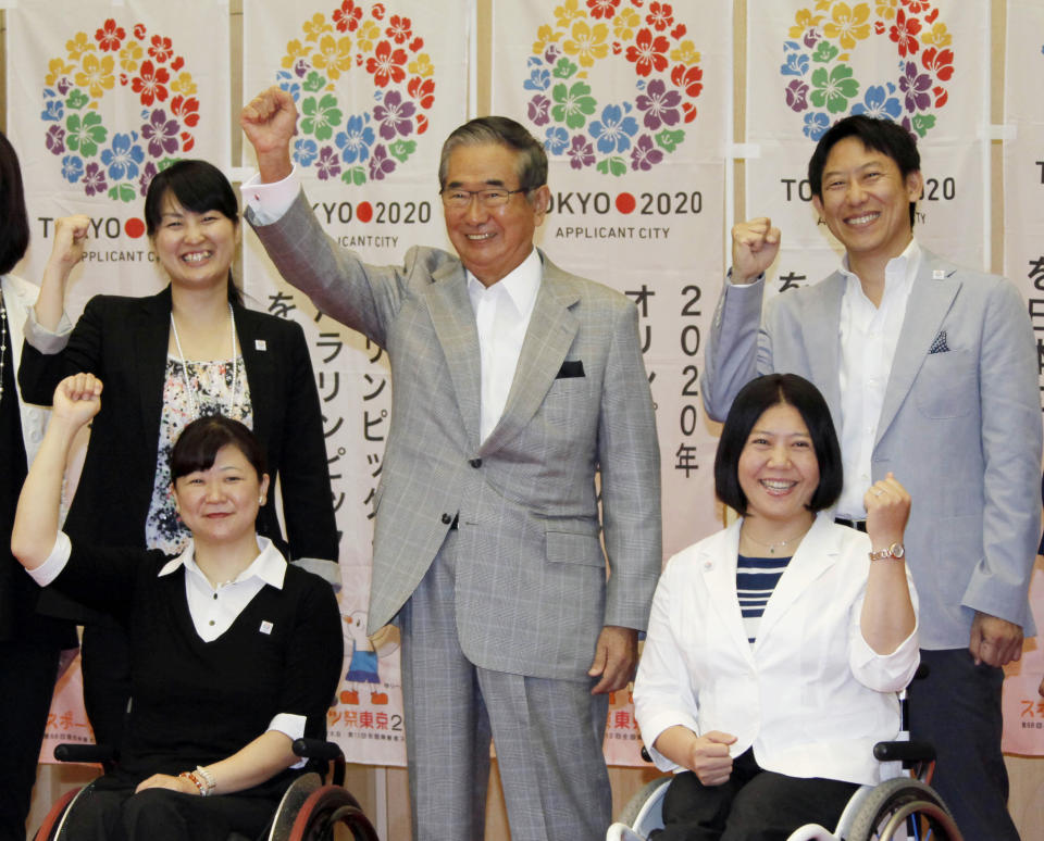 Tokyo Gov. Shintaro Ishihara, center, chairman of Tokyo 2020 Council, shows his spirit with Japanese Olympians and Paralympians during a press conference in Tokyo Thursday, May 24, 2012, after learning the Japanese capital was selected among the three finalists in the announcement of 2020 Olympic and Paralympic Games candidate cities in Quebec City, Canada. They are: Paralyjmpians, swimmer Mayumi Narita, front left, and chair skier Kuniko Obinata, front right, and Olympian swimmers, Ai Shibata, rear left, and Daichi Suzuki. (AP Photo/Koji Sasahara)