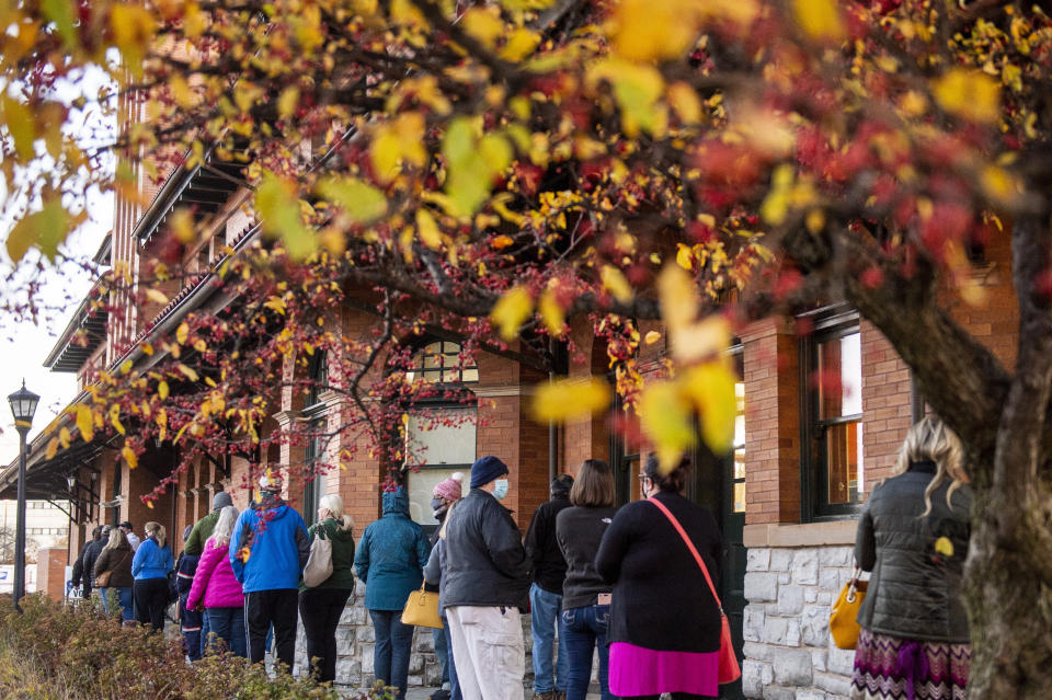 FILE - In this Tuesday, Nov. 3, 2020, file photo, voters stand in line outside of Pere Marquette Depot to cast their ballots in Bay City, Mich., on Election Day. In a move Monday, Aug. 30, 2021, Republicans are launching a ballot drive to tighten Michigan’s voting and election laws, backing a maneuver that would let GOP lawmakers enact the changes without Gov. Gretchen Whitmer’s signature. (Kaytie Boomer/The Bay City Times via AP, File)