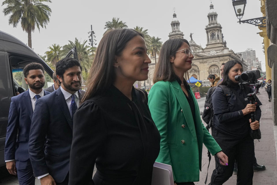 Congressman Maxwell Frost, (D-FL), from left, Congressman Greg Casar, (D-TX), and Congresswoman Alexandria Ocasio-Cortez, (D-NY), are received by Mayor Iraci Hassler, upon their arrival to City Hall in Santiago, Chile, Thursday, Aug. 17, 2023. The representatives are part of a US delegation who traveled to the South American country to learn about efforts to defend its democracy ahead of the 50th anniversary of the military coup led by Gen. Augusto Pinochet. (AP Photo/Esteban Felix)