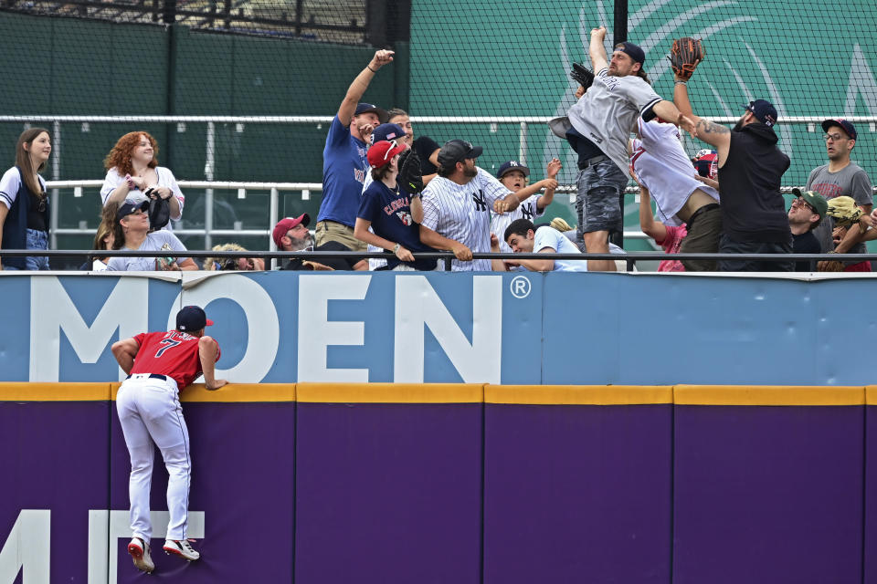 Cleveland Guardians center fielder Myles Straw jumps but is unable to reach a home run hit by New York Yankees' Anthony Rizzo during the fourth inning in the second baseball game of a doubleheader Saturday, July 2, 2022, in Cleveland. (AP Photo/David Dermer)