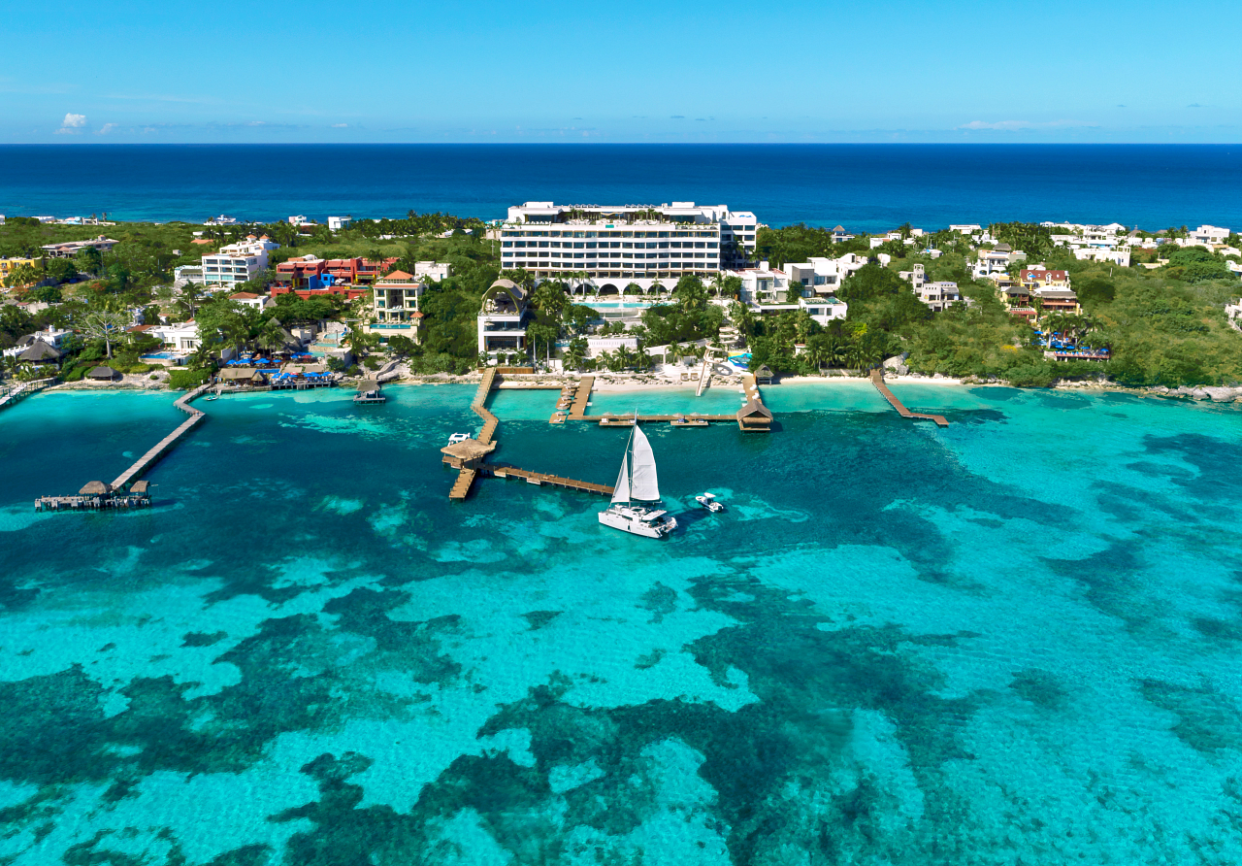 The water surrounding Isla Mujeres is a vivid blue.