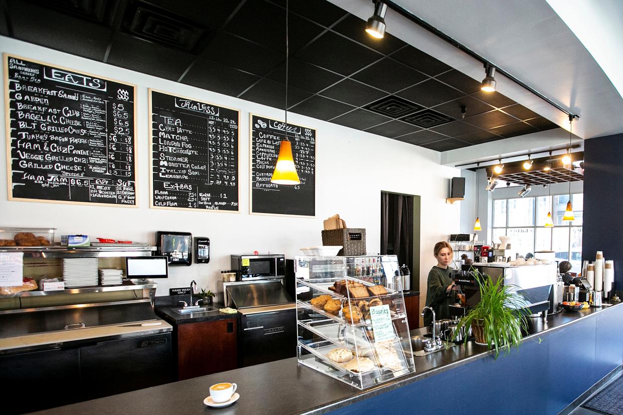 Aaliyah Warland, lead barista at Coffee Emporium, fills an order, Friday, April 7, 2023, 301 E Market Street in Iowa City, Iowa.