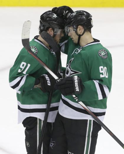Dallas Stars centers Tyler Seguin (91) and Jason Spezza (90) congratulate each other after an NHL hockey game against the Montreal Canadiens Saturday, Dec. 6, 2014, in Dallas. The Stars won 4-1. (AP Photo/LM Otero)