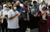 <p>People raise their hands in prayer at a vigil for the four family members who were killed in a vehicle attack that police say was motivated by anti-Muslim hate, in London, Ont., in Ottawa, on Tuesday, June 8, 2021. THE CANADIAN PRESS/Justin Tang</p> 