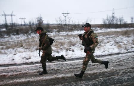 Pro-Russian separatists from the Chechen "Death" battalion run during a training exercise in the territory controlled by the self-proclaimed Donetsk People's Republic, eastern Ukraine, December 8, 2014. REUTERS/Maxim Shemetov