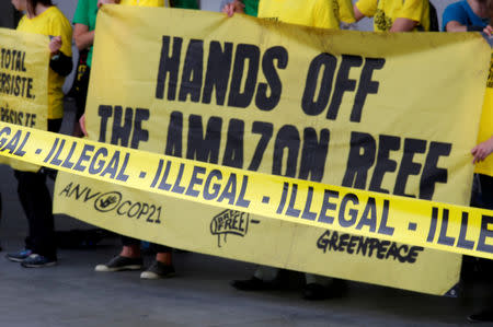 FILE PHOTO: Greenpeace activists demonstrate outside the Palais des Congres after they disrupted Total's annual shareholders meeting in protest against the French oil and gas major's quest to the drill in the ecologically sensitive Amazon basin and French Guyana, in Paris, France, June 1, 2018. REUTERS/Philippe Wojazer/File Photo