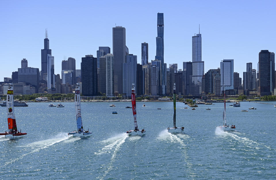 In this image provided by SailGP, the F50 catamaran fleet sail towards the Chicago skyline on Race Day 1 of United States Sail Grand Prix sailing race on Lake Michigan, Saturday, June 18, 2022, in Chicago. (Jon Buckle/SailGP via AP)