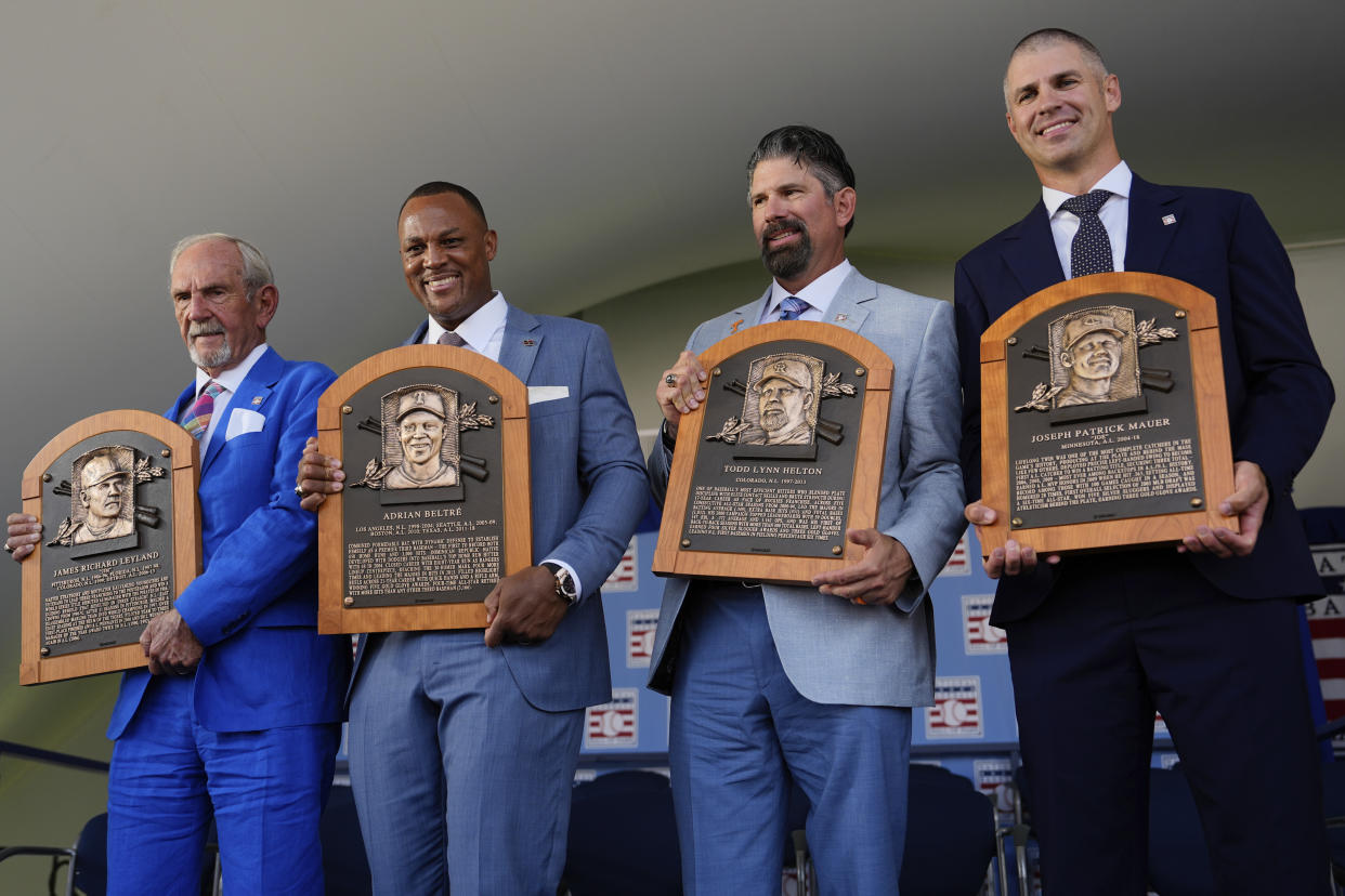 Baseball Hall of Fame inductees, from left, Jim Leyland, Adrián Beltré, Todd Helton and Joe Mauer hold their plaques at the National Baseball Hall of Fame induction ceremony on Sunday in Cooperstown. (AP Photo/Julia Nikhinson)