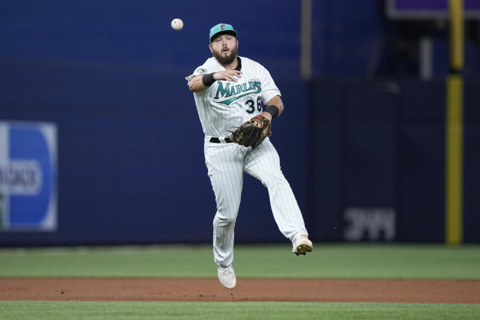 Miami Marlins third baseman Jake Burger throws to first to put out Washington Nationals' Lane Thomas during the first inning of a baseball game, Friday, Aug. 25, 2023, in Miami. (AP Photo/Wilfredo Lee)