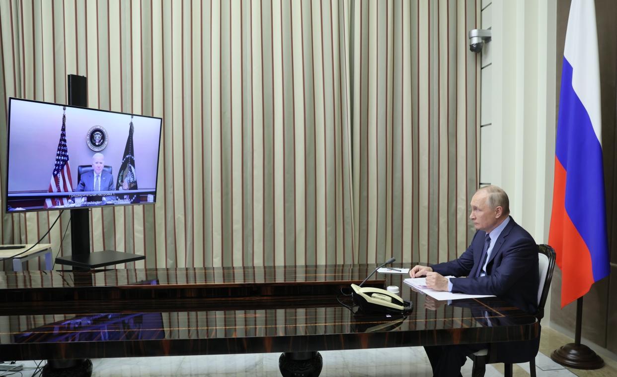FILE - Russian President Vladimir Putin sits during his talk with U.S. President Joe Biden via video conference in the Bocharov Ruchei residence in the Black Sea resort of Sochi, Russia, Dec. 7, 2021. Biden warned Putin that Moscow would face "economic consequences like you've never seen" if it invades Ukraine, although he noted that Washington would not deploy its military forces there. (Mikhail Metzel, Sputnik, Kremlin Pool Photo via AP, File)