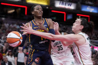 Indiana Fever center Temi Fagbenle (14) passes over New York Liberty forward Breanna Stewart (30) in the second half of a WNBA basketball game, Thursday, May 16, 2024, in Indianapolis. (AP Photo/Michael Conroy)