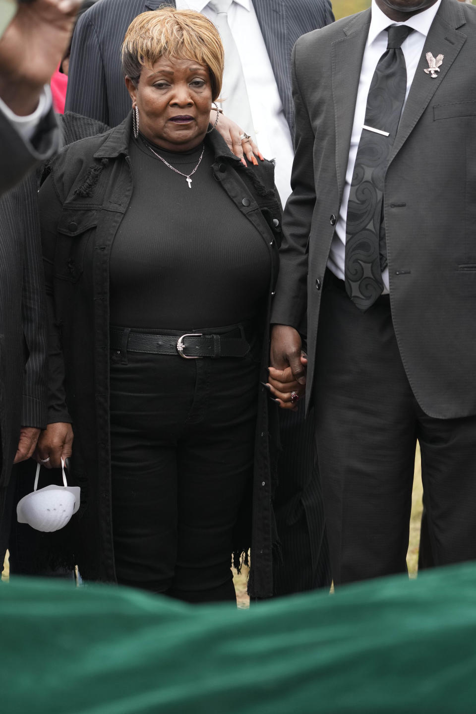 Bettersten Wade, mother of Dexter Wade, a 37-year-old man who died after being hit by a Jackson, Miss., police SUV driven by an off-duty officer, watches her son's body transferred to a mortuary transport, after being exhumed from a pauper's cemetery near the Hinds County Penal Farm in Raymond, Monday, Nov. 13, 2023. Civil rights attorney Ben Crump said Monday he is asking the U.S. Justice Department to investigate why authorities waited several months to notify the family of his death. (AP Photo/Rogelio V. Solis)