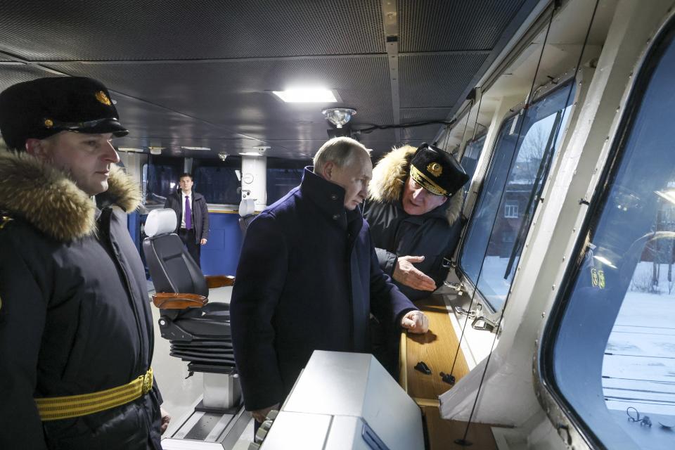 Russian President Vladimir Putin, center, and Admiral Nikolai Yevmenov, Commander-in-Chief of the Russian Navy, right, visit the newest frigate "Admiral of the fleet Kasatonov" during attending a flag-raising ceremony on Monday for newly-built nuclear submarines at the Sevmash shipyard in Severodvinsk in Russia's Archangelsk region, Monday, Dec. 11, 2023. The navy flag was raised on the Emperor Alexander III and the Krasnoyarsk submarines during Monday's ceremony. Putin has traveled to a northern shipyard to attend the commissioning of new nuclear submarines, a visit that showcases the country's nuclear might amid the fighting in Ukraine. (Mikhail Klimentyev, Sputnik, Kremlin Pool Photo via AP)