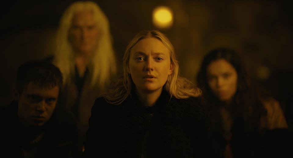 Mina (Dakota Fanning, center) ventures into woods and finds her way in with a group of strangers (Oliver Finnegan, Olwen Fouéré and Georgina Campbell) watched nightly by odd forest creatures in "The Watchers."