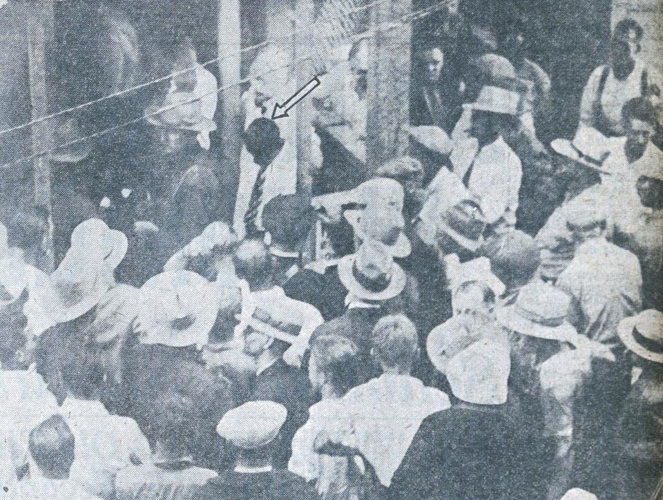 State troopers protect Herbert Johnson from a mob yelling for him to be lynched as he is returned to the Schoharie County Jail after being captured by a posse. This photo was originally published in the (Albany) Times Union, which added the arrow pointing out Johnson.