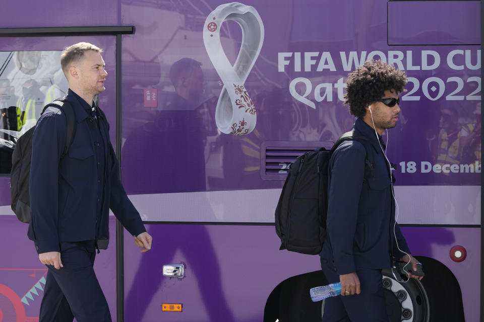 Manuel Neuer, left, and Serge Gnabry of Germany's national soccer team arrive with teammates at Hamad International airport in Doha, Qatar, Thursday, Nov. 17, 2022 ahead of the upcoming World Cup. Germany will play the first match in the World Cup against Japan on Nov. 23. (AP Photo/Hassan Ammar)