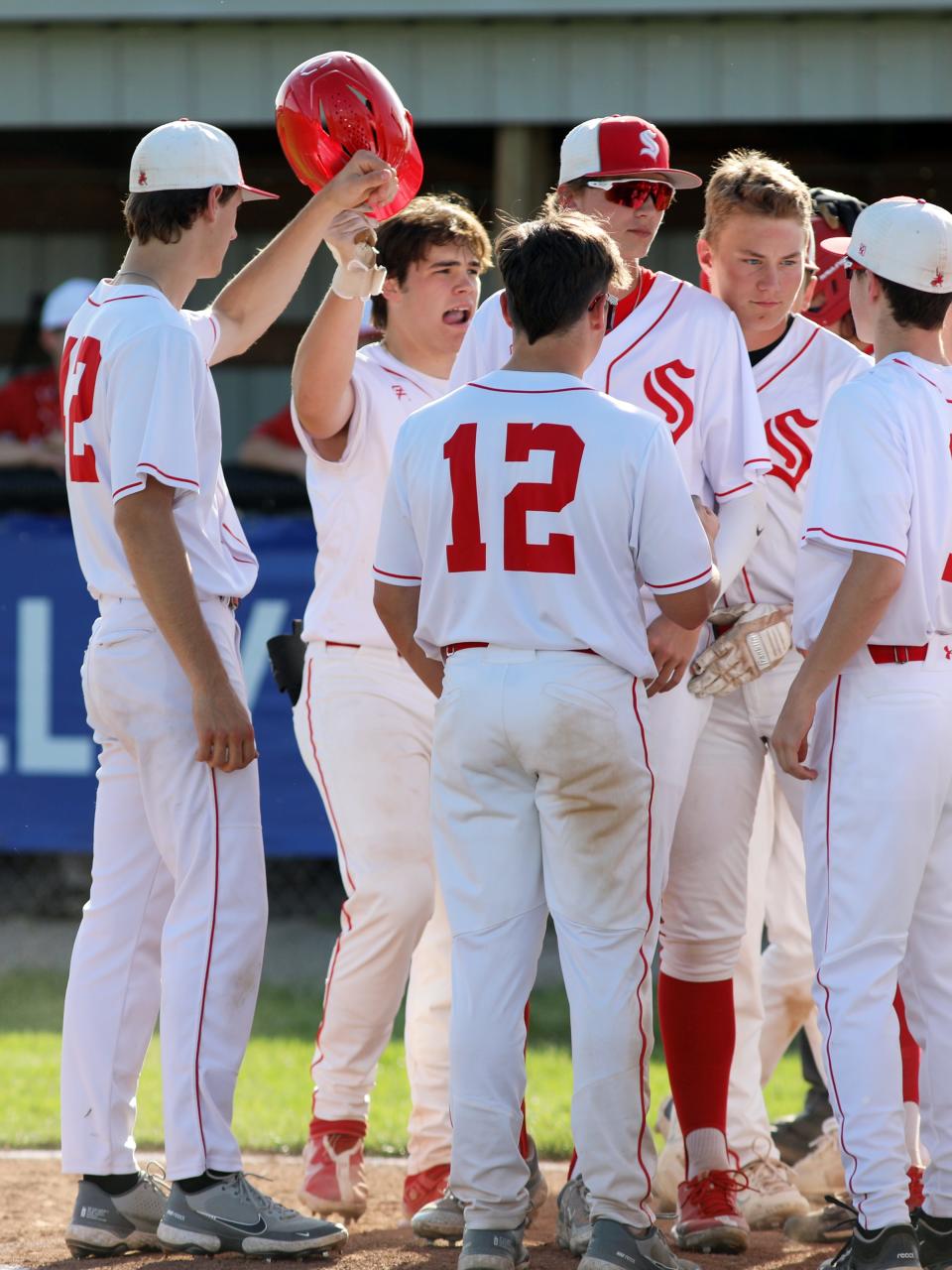 Caden Sheridan is congratulated by teammates after hitting a home run during Sheridan's 10-2 win against Hillsboro in a Division II sectional in May 2023.
