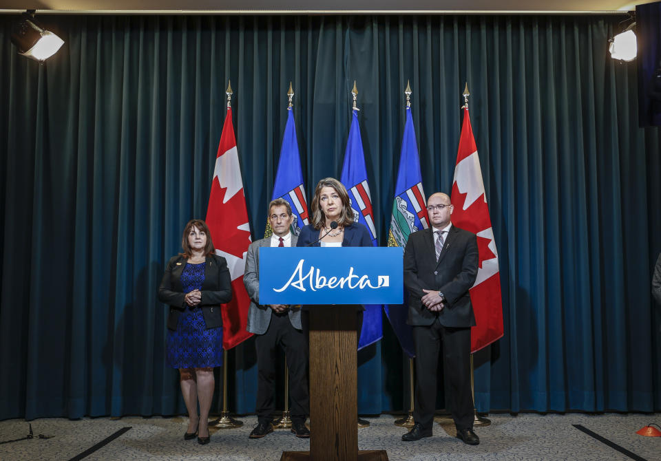 Alberta Premier Danielle Smith, centre, speaks to the media about an E-coli outbreak at several Calgary daycares, as, left to right,  Adriana LaGrange, Minister of Health, Dr. Mark Joffe, Alberta chief medical officer of health, and Searle Turton, Minister of Children and Family Services, look on in Calgary, Alta., Friday, Sept. 15, 2023. THE CANADIAN PRESS/Jeff McIntosh
