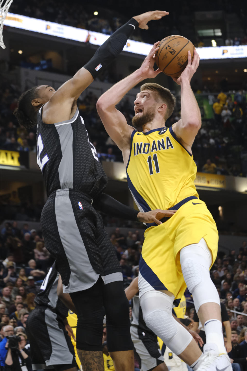 Indiana Pacers forward Domantas Sabonis (11) shoots next to Sacramento Kings forward Richaun Holmes (22) during the second half of an NBA basketball game in Indianapolis, Friday, Dec. 20, 2019. The Pacers won 119-105. (AP Photo/AJ Mast)