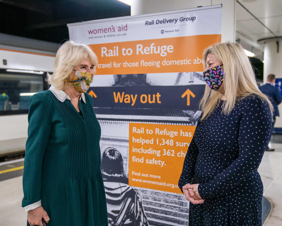 Handout photo issued by the Rail Delivery Group of the Duchess of Cornwall (left) speaking with Rail to Refuge representative, CEO of ReigateÊand Banstead WomenÕs Aid, Charlotte Kneer (right), during a visit to Victoria Station in London. Rail to Refuge is a collaboration between train operators and Women's Aid which enables survivors fleeing domestic abuse to access free train travel to a safe refuge. Issue date: Tuesday March 30, 2021.