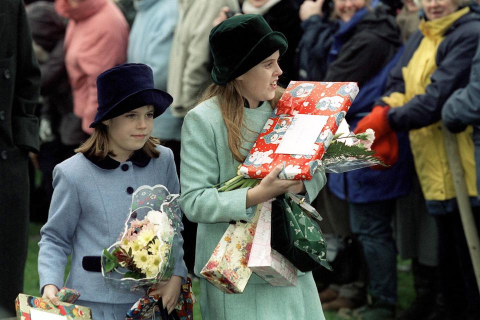 Princess Beatrice And Princess Eugenie With Gifts They Were Given By People In The Crowd Outside Church On Christmas Day At Sandringham.