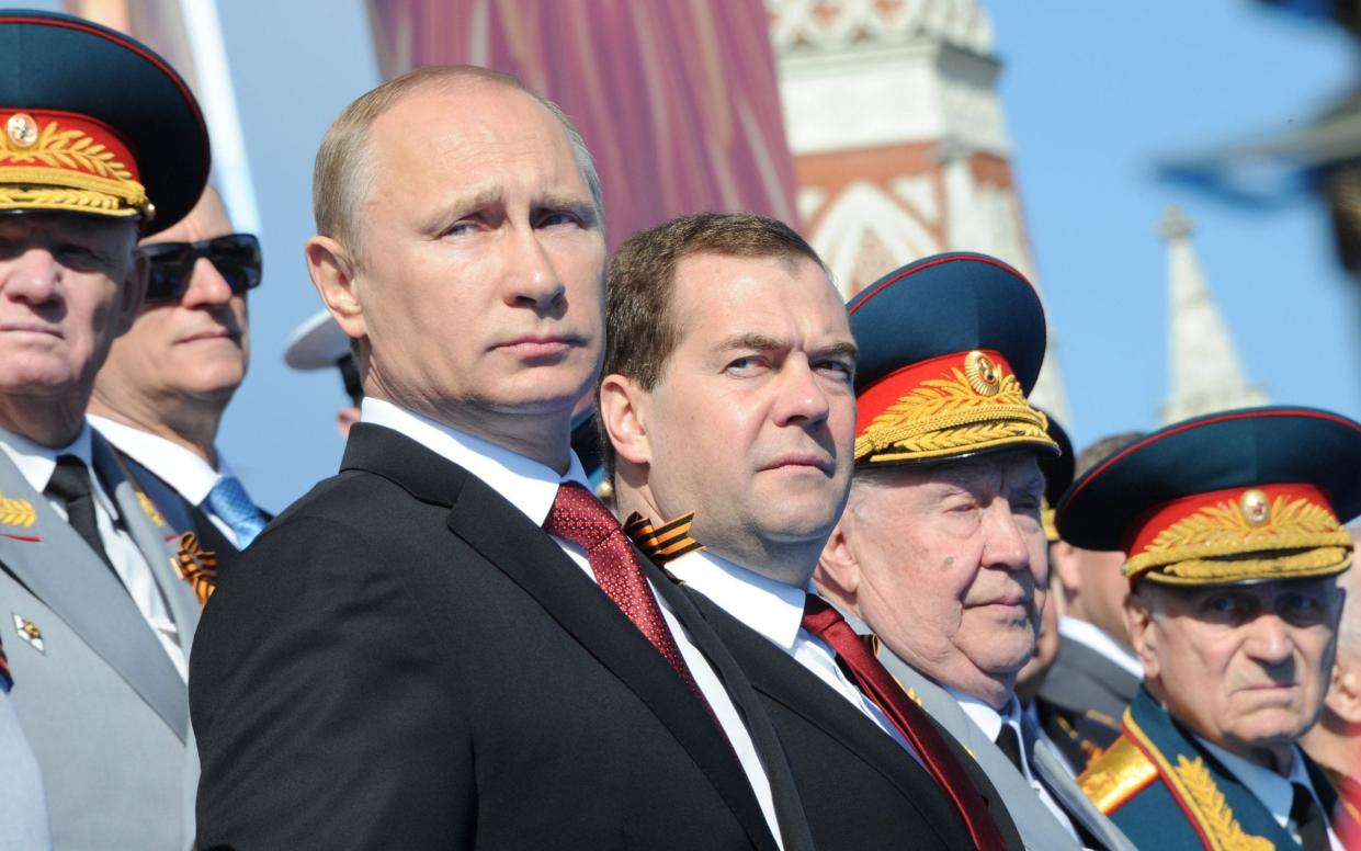 Vladimir Putin (centre left) and Dmitry Medvedev (centre right). Mr Medvedev said that a key aim for the Kremlin was to “de-nazify” Ukraine - MIKHAIL KLIMENTYEV/RIA NOVOSTI/POOL/EPA-EFE/REX/REX