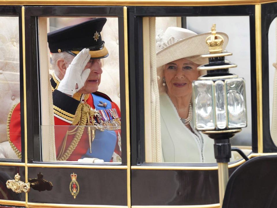Britain's King Charles III and Queen Camilla travel along The Mall for the Trooping the Color ceremony at Horse Guards Parade, London, Saturday, June 15, 2024. Trooping the Color is the King's Birthday Parade and one of the nation's most impressive and iconic annual events attended by almost every member of the Royal Family. (Jonathan Brady/PA via AP)