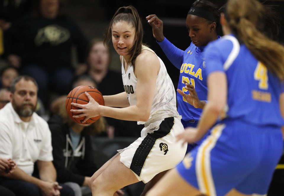 Colorado guard Emma Clarke, left, is trapped with the ball by UCLA forward Michaela Onyenwere, back right, and guard Lindsey Corsaro in the first half of an NCAA college basketball game Sunday, Jan. 12, 2020, in Boulder, Colo. (AP Photo/David Zalubowski)