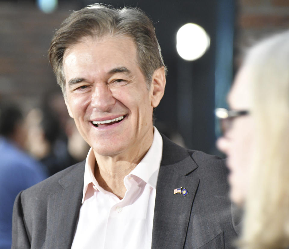 Mehmet Oz, the TV celebrity and heart surgeon who is running for the Republican nomination for U.S. Senate in Pennsylvania, laughs while talking to attendees after he spoke at a town hall-style event at the Newtown Athletic Club, Feb. 20, 2022, in Newtown, Pa. (AP Photo/Marc Levy)