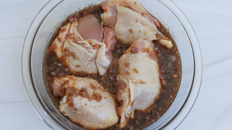 chicken thighs marinating in bowl 