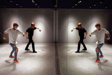 A member of China's all-girl "boyband" FFC-Acrush practices a dance routine with a coach at a dance studio in Beijing April 27, 2017. Picture taken April 27, 2017. REUTERS/Thomas Peter