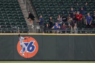 Seattle Mariners fans react as Minnesota Twins center fielder Nick Gordon leaps but can't catch a go-head solo home run hit by Seattle Mariners' Jake Bauers during the eighth inning of a baseball game, Monday, June 14, 2021, in Seattle. (AP Photo/Ted S. Warren)