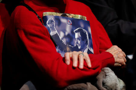 A supporter holds a program as Francois Fillon, former French Prime Minister, member of the Republicans political party and 2017 presidential election candidate of the French centre-right delivers a speech at a campaign rally in Aubervilliers, Paris suburb, March 4, 2017. REUTERS/Philippe Wojazer