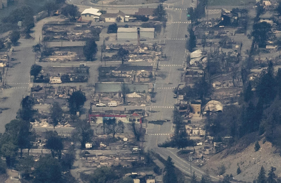 In this aerial photo taken from a helicopter, structures destroyed by wildfire are seen in Lytton, British Columbia, on Thursday, July 1, 2021. Lytton city council member Lilliane Graie, on behalf of Mayor Jan Polderman, said in an email Thursday that the fire had devastated the town, a village about 153 kilometers (95 miles) northeast of Vancouver. (Darryl Dyck/The Canadian Press via AP)