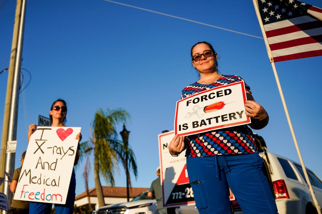 Demonstrators protest on the Roosevelt Bridge against the federal COVID-19 vaccine mandate on Nov. 26, 2021, in Stuart, Fla. The protest was in support of health care workers who will face unemployment because of the mandate.