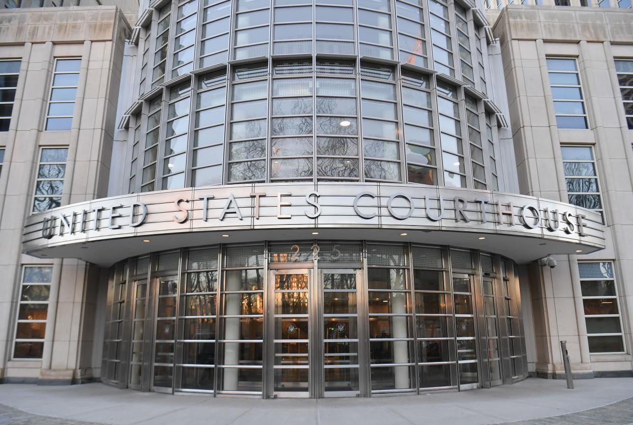 Large, curved building entryway with sign: United States Courthouse