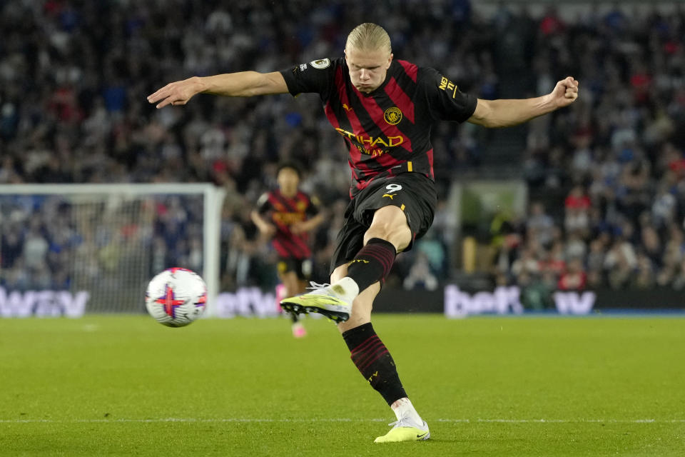 Manchester City's Erling Haaland takes a shot during the English Premier League soccer match between Brighton and Hove Albion and Manchester City at the AMEX stadium in Brighton, England, Wednesday, May 24, 2023. (AP Photo/Kirsty Wigglesworth)