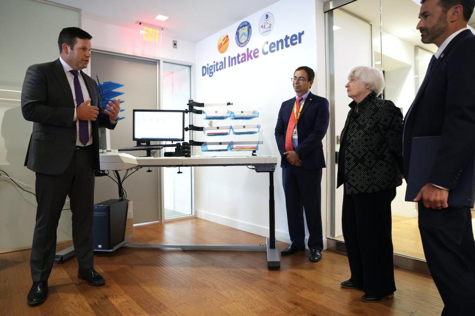 Director of Enterprise Digitalization of 22nd Century Technologies Harrison Smith, left, demonstrates the digital intake initiative, a scanning technology for IRS paperless processing, as Secretary of the Treasury Janet Yellen and IRS Commissioner Daniel Werfel, right, look on in August 2023. <a href="https://www.gettyimages.com/detail/news-photo/director-of-enterprise-digitalization-of-22nd-century-news-photo/1588274665?adppopup=true" rel="nofollow noopener" target="_blank" data-ylk="slk:Alex Wong/Getty Images;elm:context_link;itc:0;sec:content-canvas" class="link ">Alex Wong/Getty Images</a>