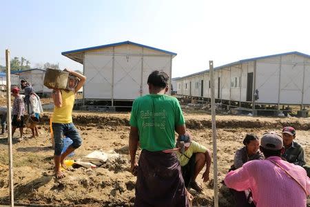 People work inside a camp set up by Myanmar's Social Welfare, Relief and Resettlement Minister to prepare for the repatriation of displaced Rohingyas, who fled to Bangladesh, outside Maungdaw in the state of Rakhine, Myanmar January 24, 2018. REUTERS/Stringer