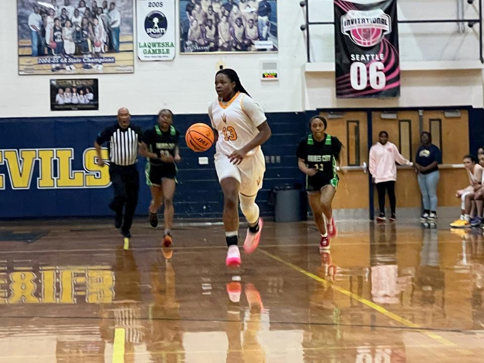 Serentiy Hardy dribbles down the court vs. Haines City on Feb. 9, 2024 at Winter Haven High School. The Blue Devils won the Class 7A, District 9 title game thanks to Hardy's 25 points.