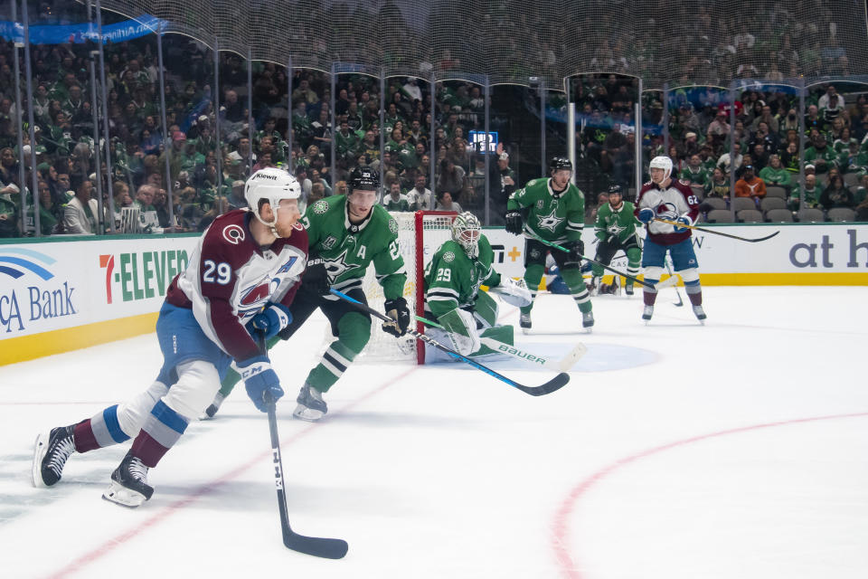 Colorado Avalanche center Nathan MacKinnon (29) looks to pass the puck as Dallas Stars left wing Mason Marchment (27) defends during the second period of an NHL hockey game, Saturday, March 4, 2023, in Dallas. (AP Photo/Emil T. Lippe)