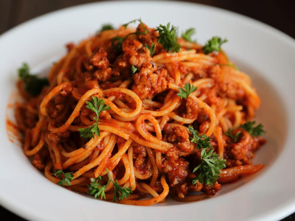 spaghetti bolognese in a white bowl