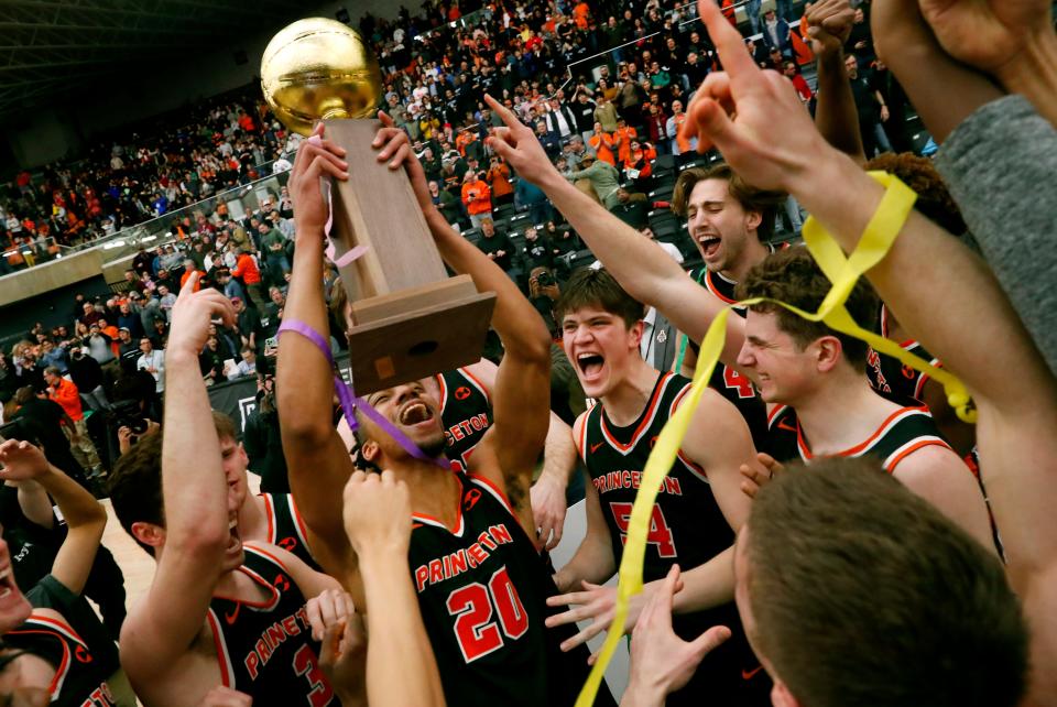 Princeton forward Tosan Evbuomwan (20) celebrates with teammates after defeating Yale 74-65 during the Ivy League championship NCAA college basketball game, Sunday, March 12, 2023, in Princeton, N.J.