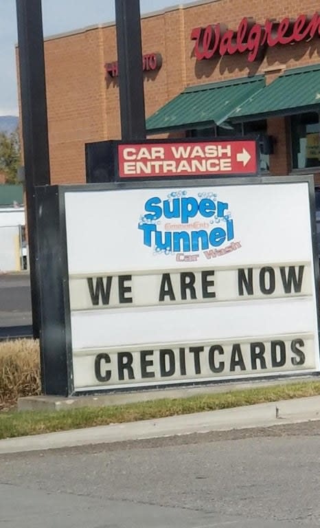 sign reading we are now credit cards