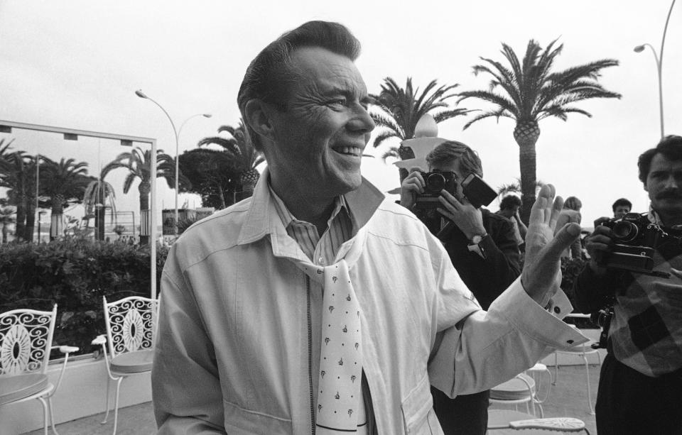 British actor Dirk Bogarde at the 37th International Cannes Film Festival are in front of the Carlton Hotel, near the Cannes Croisette on May 12, 1984. (AP Photo/Michel Lipchitz)