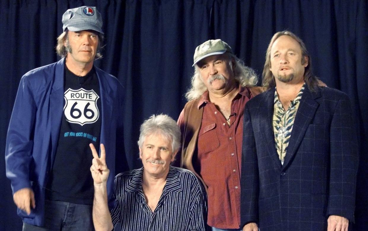 Neil Young, Graham Nash, David Crosby, and Stephen Stills at a 1999 press conference - Reuters