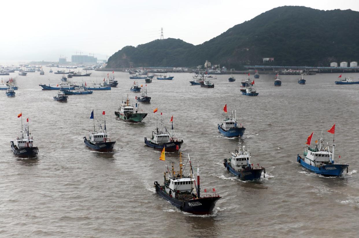 <span class="caption">China has clashed with neighbors over its fishing in the contested South China Sea, pictured here. Controversially, Chinese fishermen also venture as far as Argentina and Ecuador.</span> <span class="attribution"><a class="link " href="https://www.gettyimages.com/detail/news-photo/fishing-boats-set-sail-for-fishing-after-the-four-and-a-news-photo/1272762923?adppopup=true" rel="nofollow noopener" target="_blank" data-ylk="slk:Yao Feng/VCG via Getty Images;elm:context_link;itc:0;sec:content-canvas">Yao Feng/VCG via Getty Images</a></span>